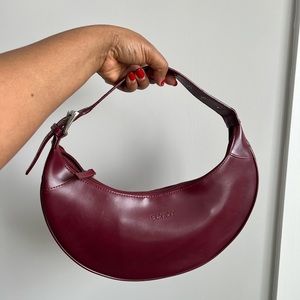 Burgundy moon shaped shoulder bag